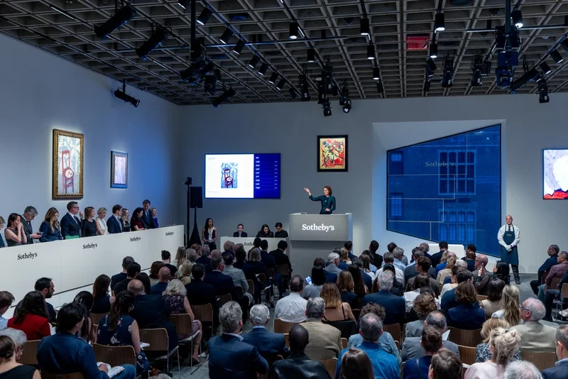 Crowded fine-art auction room